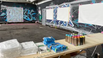 Graffiti workshop space with art supplies.