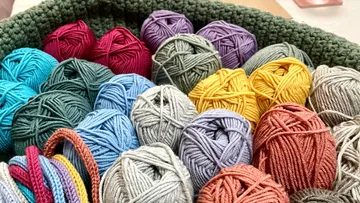 Colorful yarn balls in a basket.