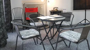 Chairs and table in cozy room setting.