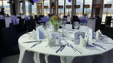 Elegantly set round table in banquet hall.