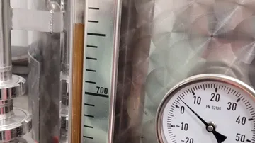Gauge and level indicator on metal tank.