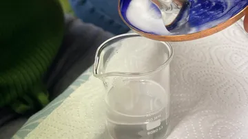Liquid poured from dish into beaker, on paper towel.