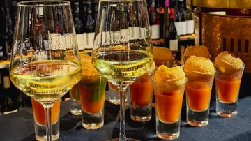 Wine glasses with sorbet and drinks in bar setting.