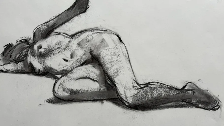 Charcoal drawing of a reclining nude figure.
