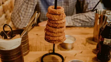 Stacked onion rings on a metal stand.