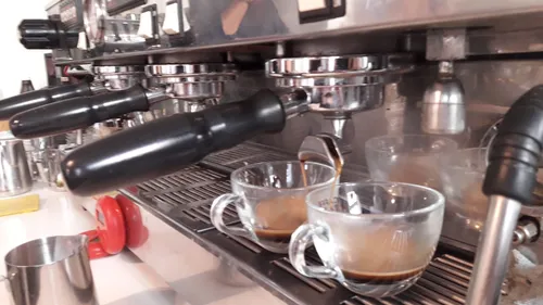 Espresso machine pouring into two cups