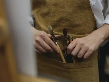 Brush in an apron, hands grab them.