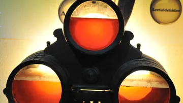 Three orange-lit glass circles on a device.