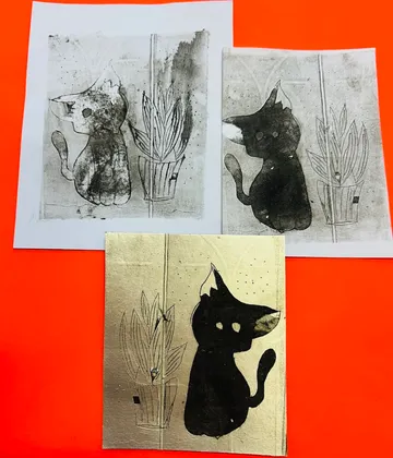 Three cat art prints on orange background.