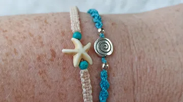Woven bracelets with starfish and spiral charms.