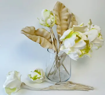 White flowers and beige leaves in vase