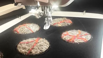 Embroidery machine sewing round wool patterns.