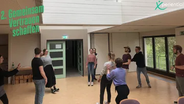 Gruppe im Kreis während der Teambuilding-Aktivität