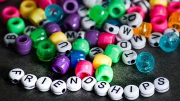 Colorful beads with 'FRIENDSHIPS' spelled out.