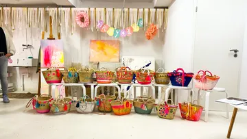 Colorful painted baskets displayed in art studio.