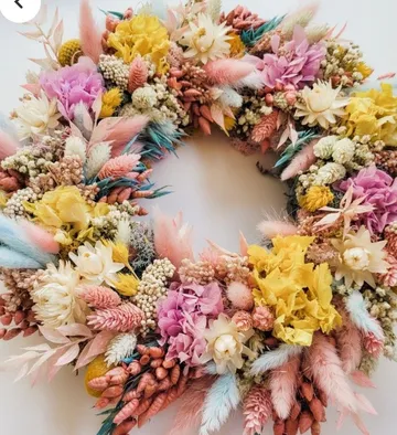 Colorful dried flower wreath with pinks and yellows.