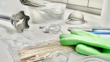 Kitchen utensils on marble countertop.