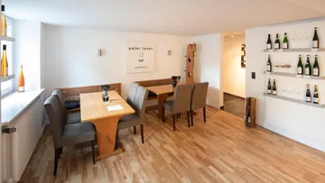 Cozy wine tasting room with wooden tables.
