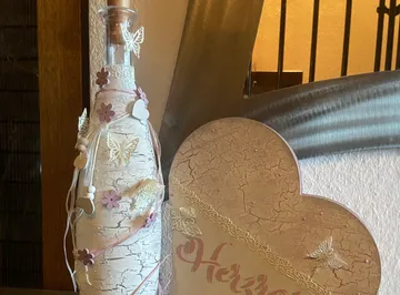 Decorative bottle with butterflies and flowers.