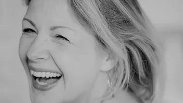 Smiling woman, close-up, black and white.