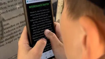 Person reading text on smartphone screen.
