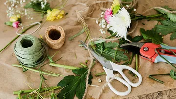Florist tools and materials on table.
