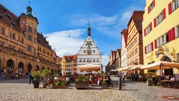 People dining in a historic town square.