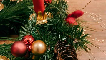 Christmas wreath with colorful ornaments and candle