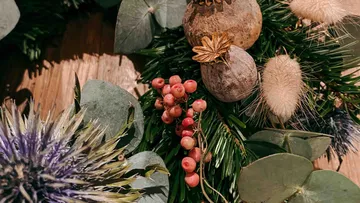 Decorative wreath with berries and foliage.
