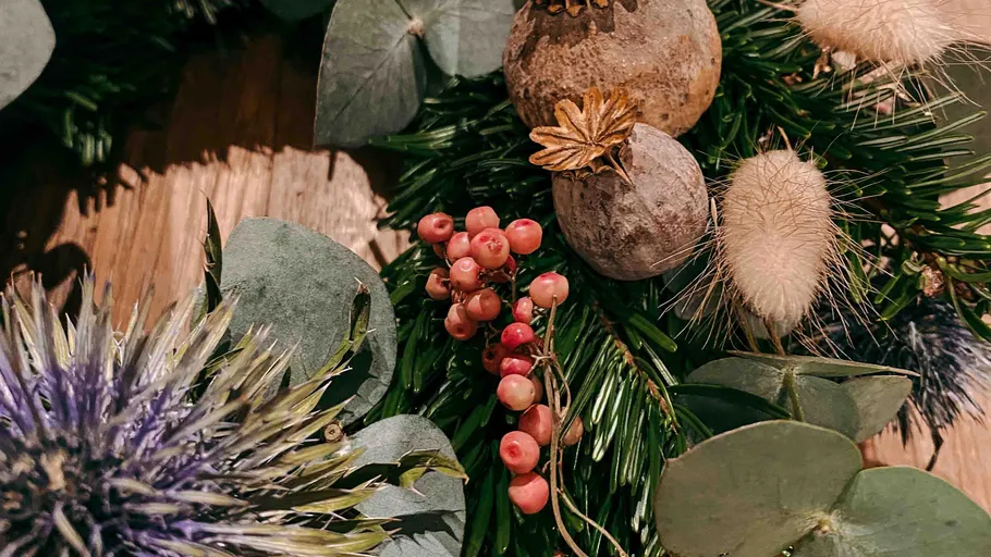 Decorative wreath with berries and foliage.