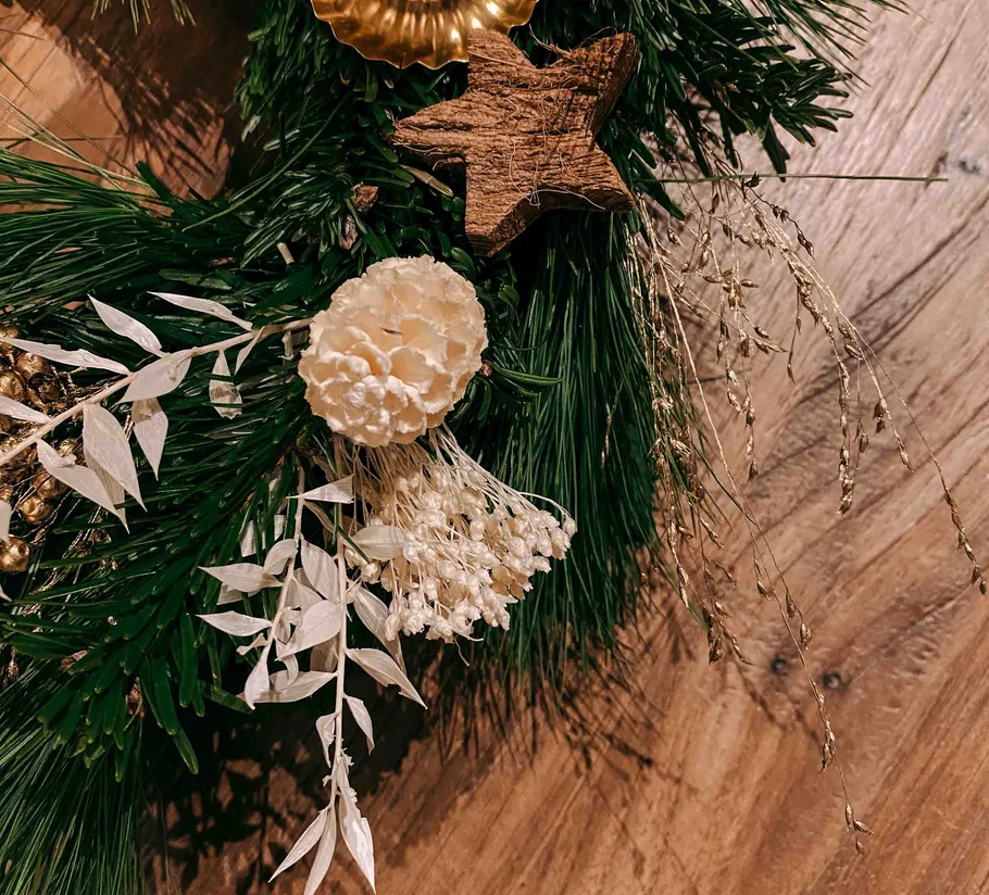 Decorative foliage and dried flowers on wood.