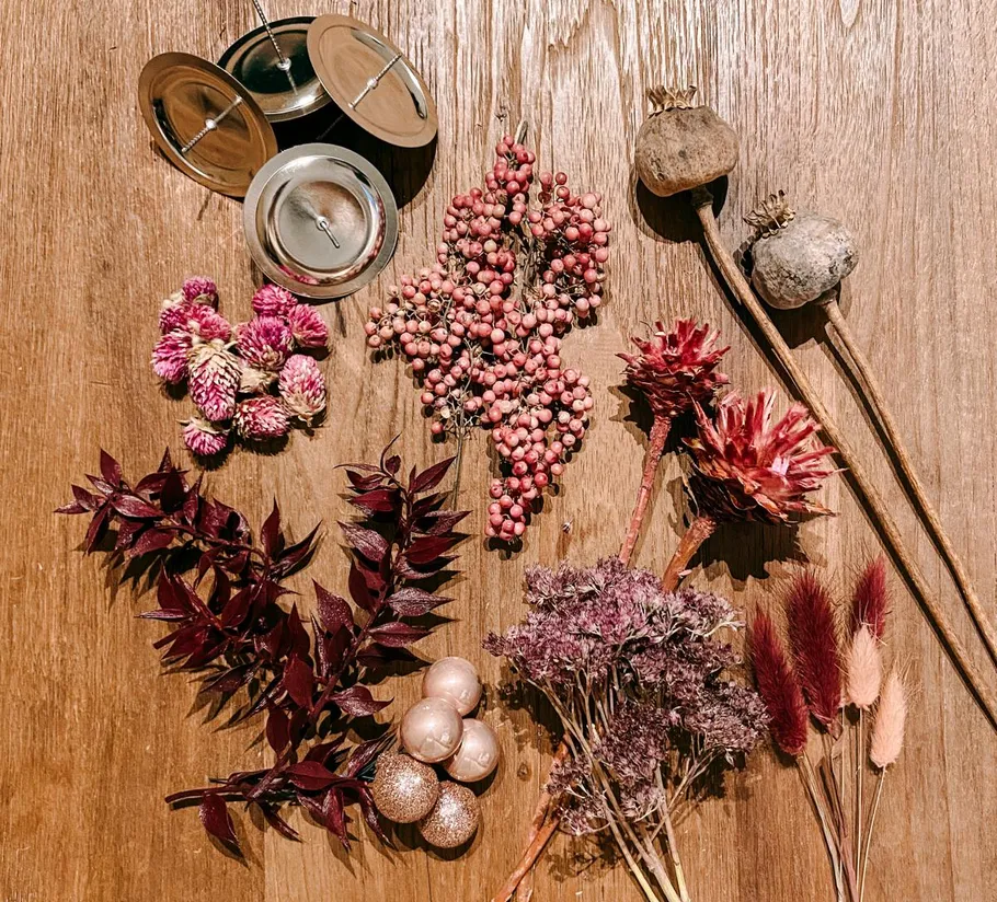 Dried botanicals and decor on wooden surface.