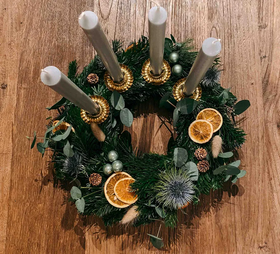 Festive wreath with candles and orange slices.