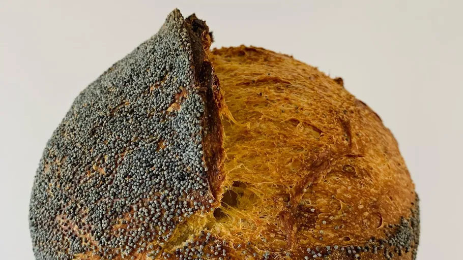 Sourdough bread with poppy seeds on crust.