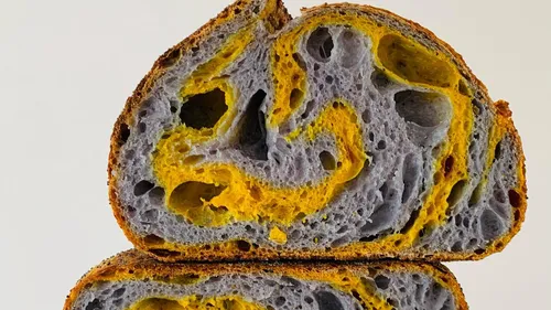 Swirled blue and yellow sourdough loaf.