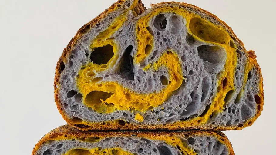 Swirled blue and yellow sourdough loaf.