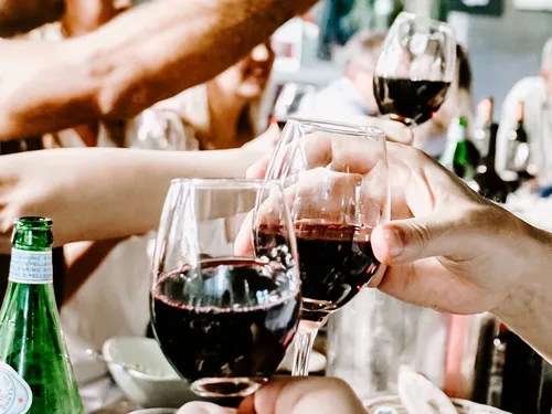 Glasses of red wine toast to celebrate.