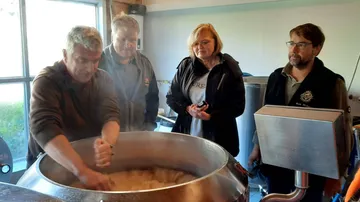 Group observing brewing process in a brewery.