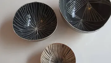 Three patterned bowls on a white surface.