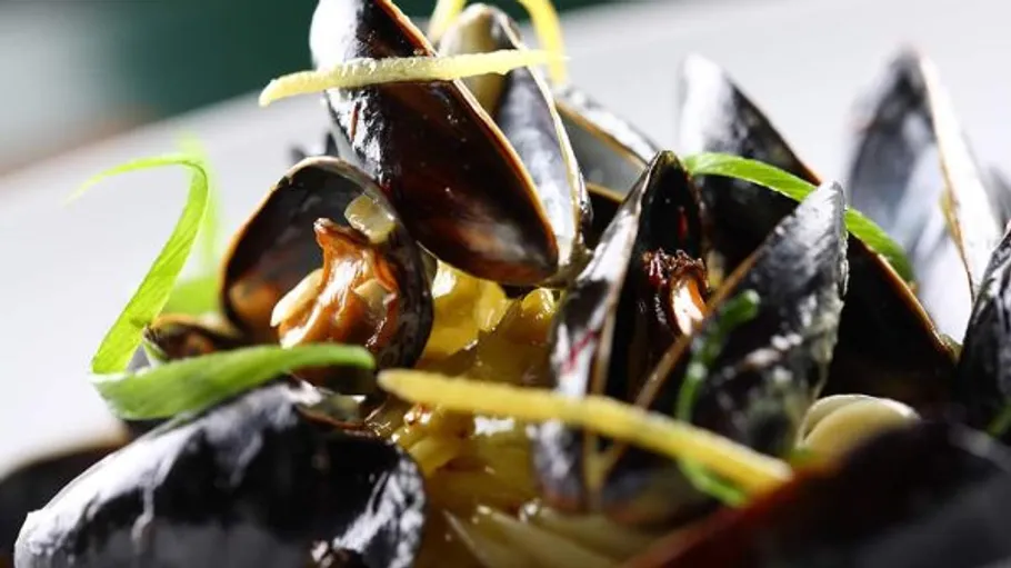 Mussels garnished with lemon and herbs.
