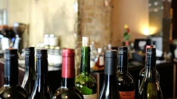 Assorted wine bottles on a bar counter.