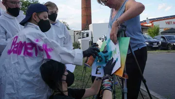 Group creating graffiti art outdoors