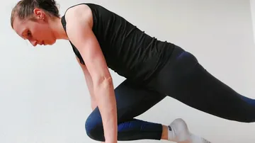 Person doing a mountain climber exercise indoors.