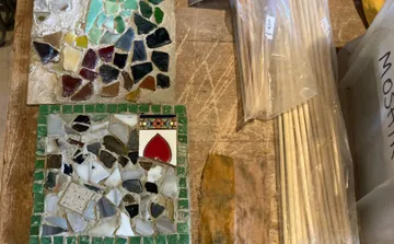 Colorful mosaic tiles on wooden table.