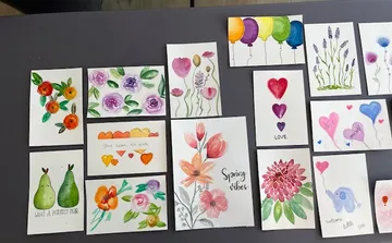 Colorful hand-painted cards with floral designs.