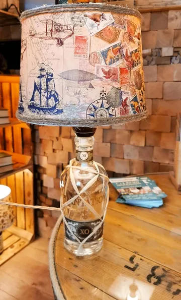 Rum bottle on wooden table, cozy setting.