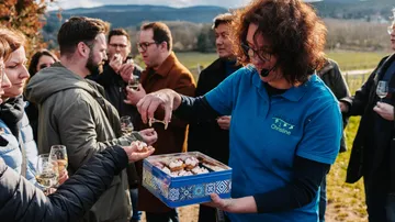 Group enjoying food and drinks outdoors.