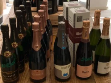 Bottles are on a wooden table, ready to be served.