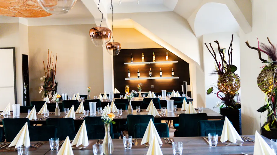 Elegant dining room with tables set, decorative plants