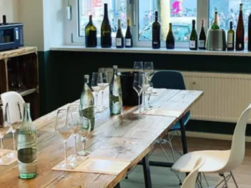 A table with glasses and bottles of water in a room.